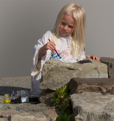 Child painting rocks